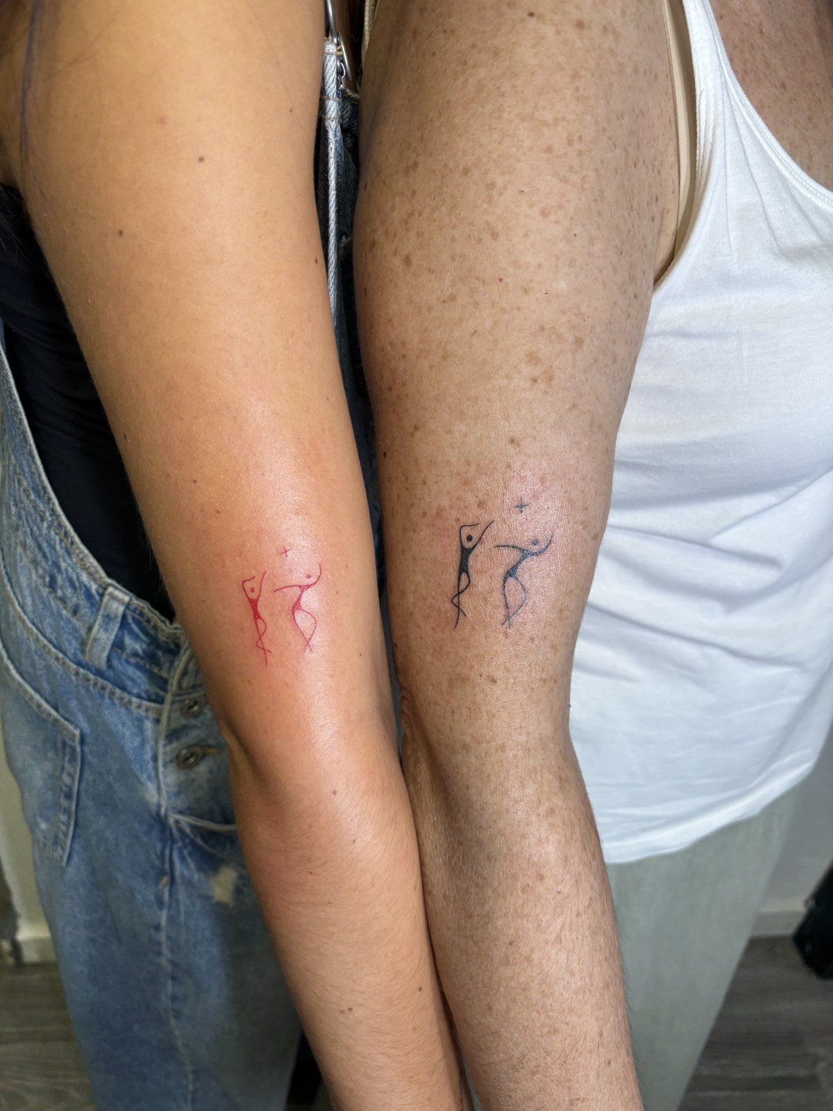 Matching fine line dancer tattoos, for a couple