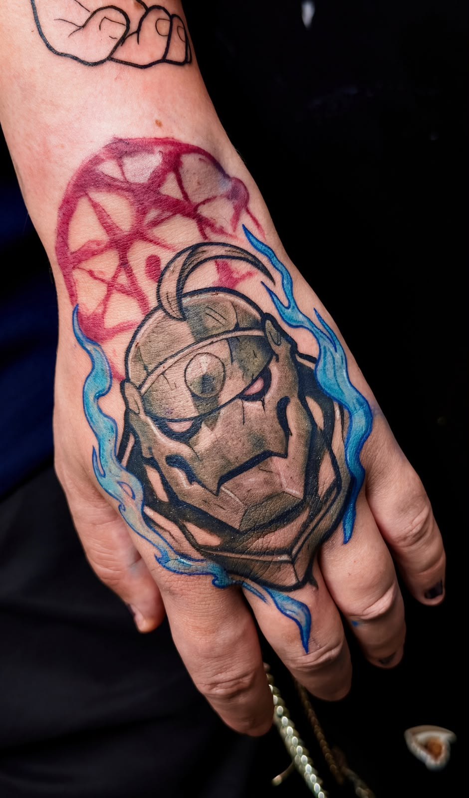 Colour hand tattoo with flames and character, by Tuiti